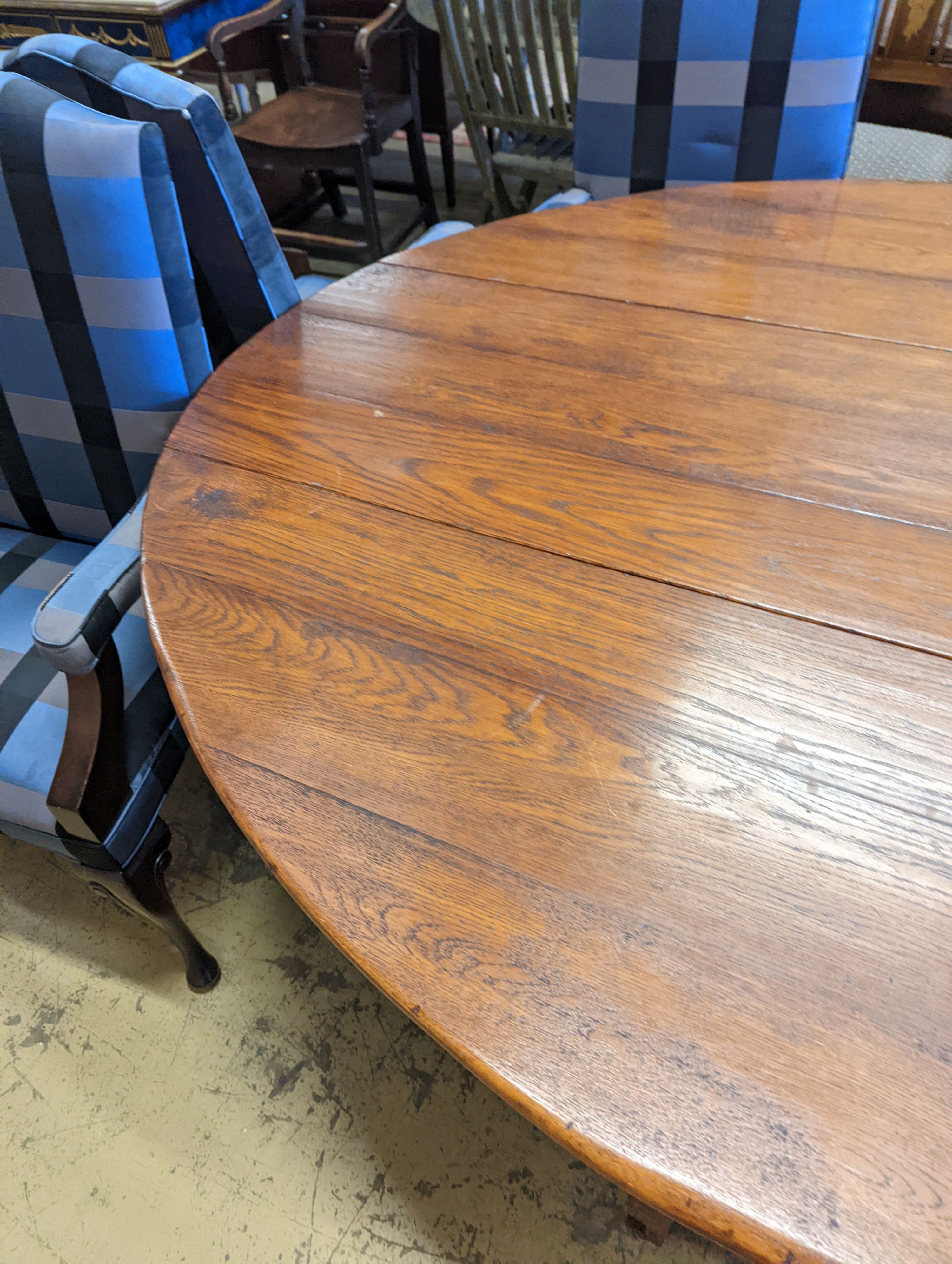 An 18th century style oak gateleg 'wake' dining table, length 200cm, 150cm extended, height 75cm